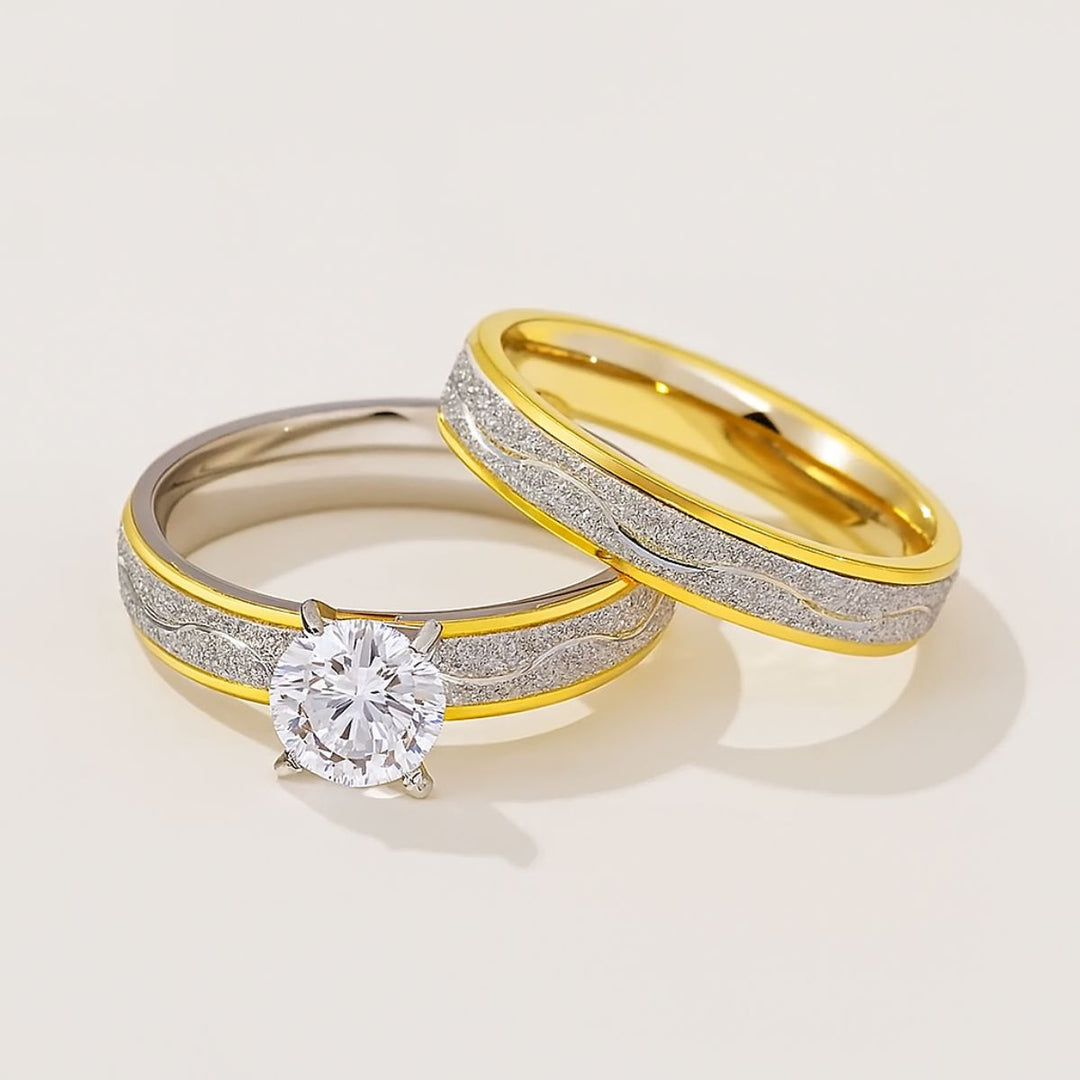 Fall in Love Rings by CouplesChoices.com—featuring a stunning round-cut solitaire and matching bands in silver and gold with textured wave accents. A radiant fusion of elegance and warmth, capturing the golden glow of timeless love.