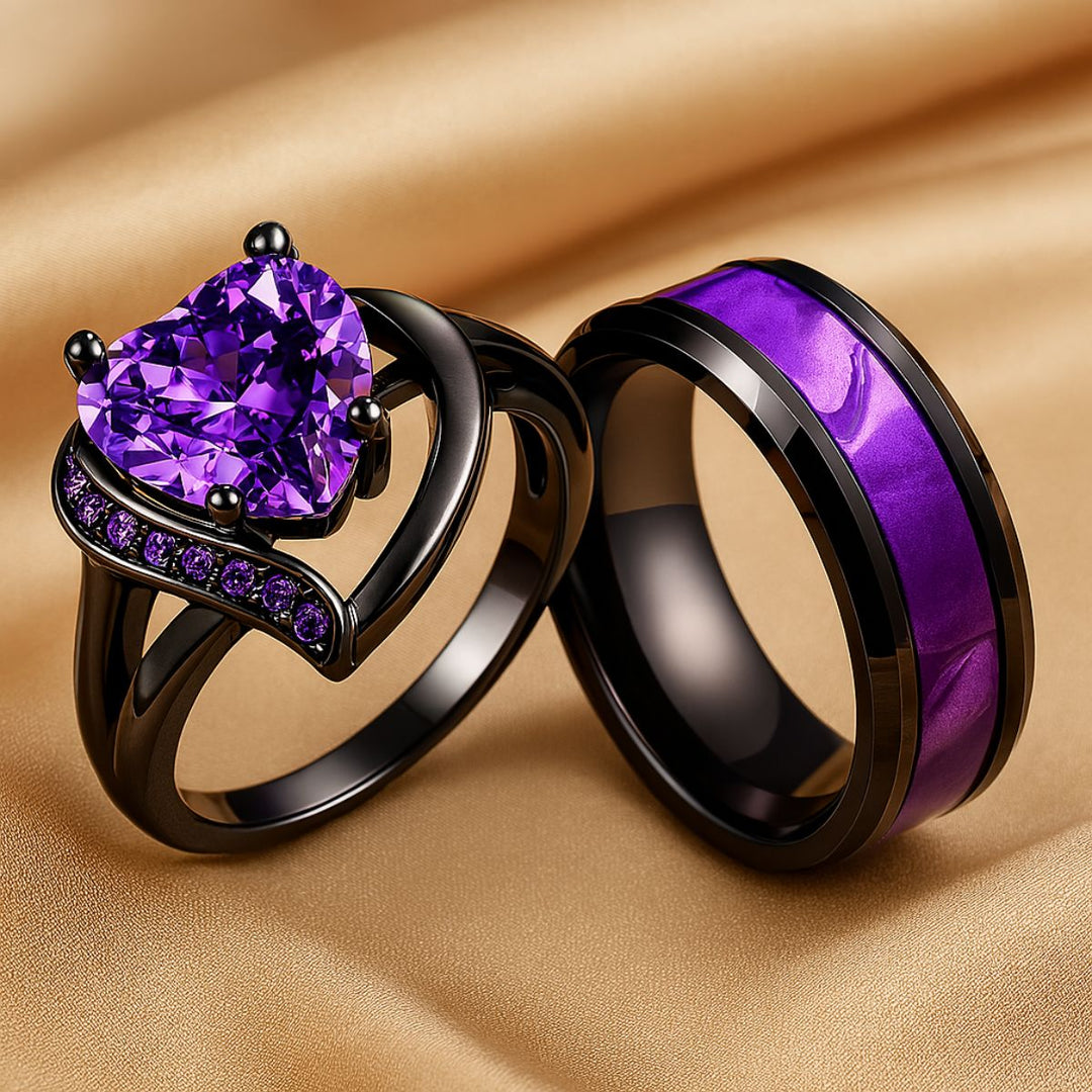 Fidelity Ring Set by CouplesChoices.com — featuring a radiant heart-shaped purple gemstone in sleek black gold with pavé violet accents, paired with a bold men’s band with a vibrant deep-amethyst inlay. A daring union of elegance.