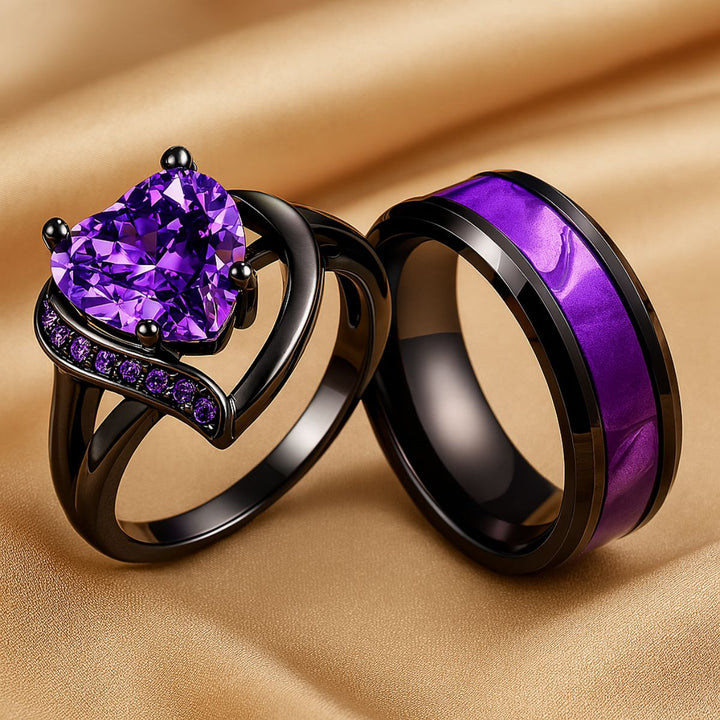 Fidelity Ring Set by CouplesChoices.com — featuring a radiant heart-shaped purple gemstone in sleek black gold with pavé violet accents, paired with a bold men’s band with a vibrant deep-amethyst inlay. A daring union of elegance.