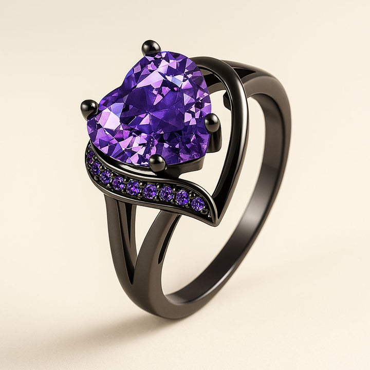 Fidelity Ring Set by CouplesChoices.com — featuring a radiant heart-shaped purple gemstone in sleek black gold with pavé violet accents, paired with a bold men’s band with a vibrant deep-amethyst inlay. A daring union of elegance.