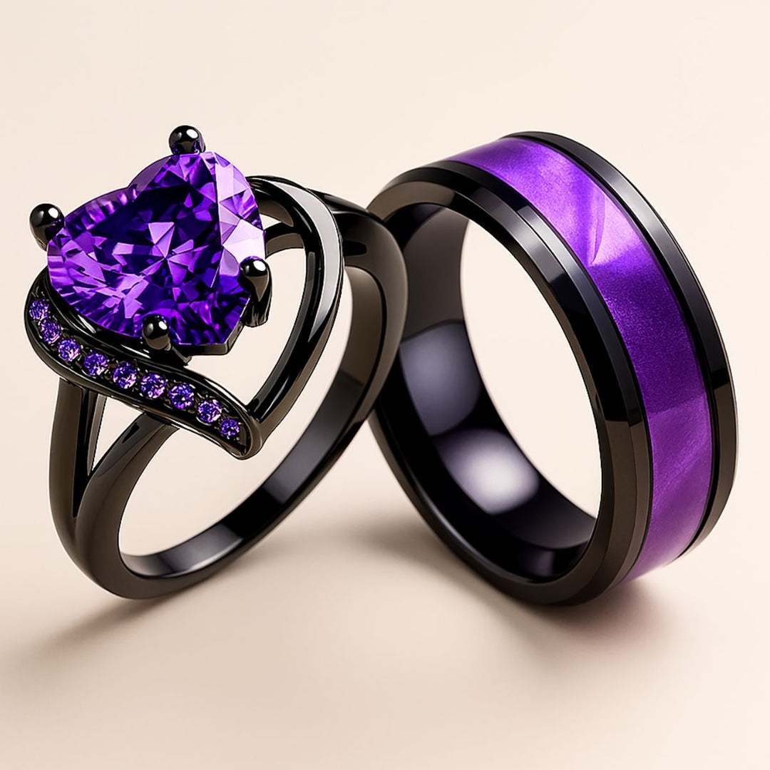 Fidelity Ring Set by CouplesChoices.com — featuring a radiant heart-shaped purple gemstone in sleek black gold with pavé violet accents, paired with a bold men’s band with a vibrant deep-amethyst inlay. A daring union of elegance.