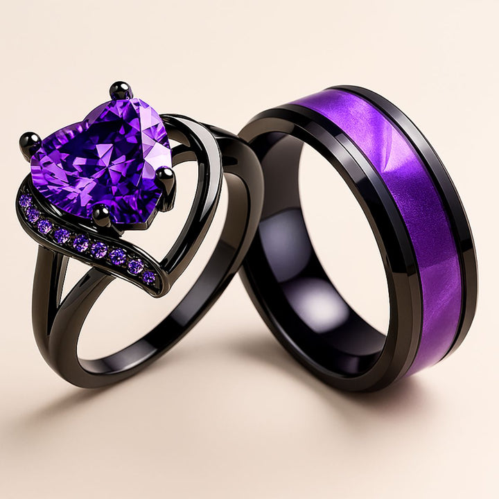 Fidelity Ring Set by CouplesChoices.com — featuring a radiant heart-shaped purple gemstone in sleek black gold with pavé violet accents, paired with a bold men’s band with a vibrant deep-amethyst inlay. A daring union of elegance.