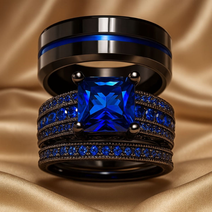 Love Dance ring set by CouplesChoices.com, featuring a bold black titanium band with electric blue inlay and a radiant princess-cut sapphire atop pavé-set blue stones—designed to move hearts.