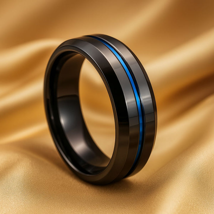 Love Dance ring set by CouplesChoices.com, featuring a bold black titanium band with electric blue inlay and a radiant princess-cut sapphire atop pavé-set blue stones—designed to move hearts.