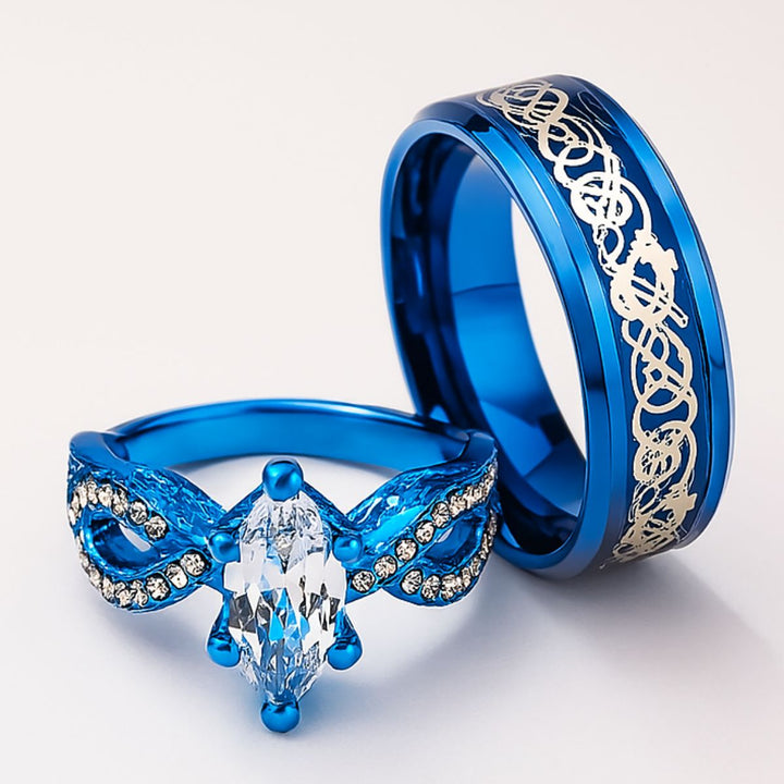 Love Lagoon rings by CouplesChoices.com—dazzling ocean-blue bands with intricate silver detailing and a marquise-cut crystal centerpiece. A breathtaking blend of artistry and romance, made for couples who love boldly and beautifully.
