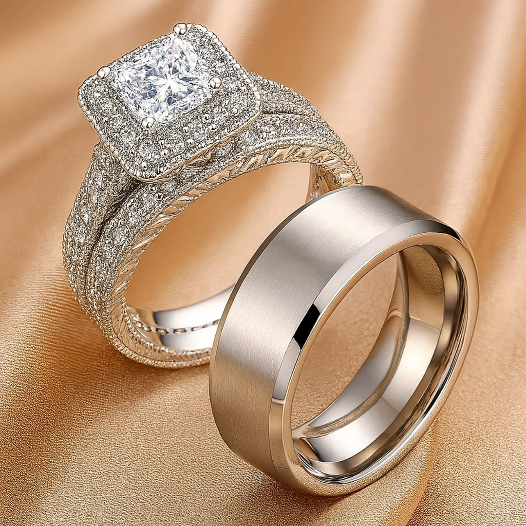 Love Mountain Rings by CouplesChoices.com—an exquisite bridal set with a princess-cut centerpiece framed in pavé brilliance, paired with a bold, brushed band. Designed for enduring love that stands tall, timeless, and unshakable.