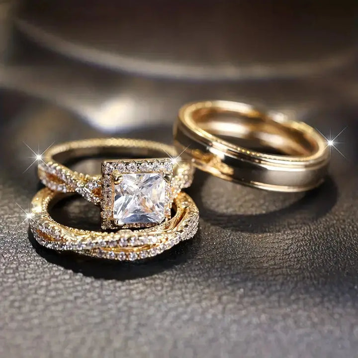 Lumina ring set by CouplesChoices.com, showcasing a princess-cut center stone on a pavé infinity band in radiant gold, paired with a matching gold men’s band for a timeless, luminous union.