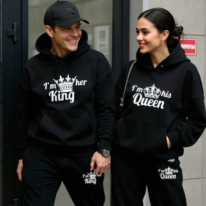 Matching black King and Queen couples tracksuits with white crown prints and bold text reading 'I'm her King' and 'I'm his Queen,' from CouplesChoices.com. Perfect for stylish partners looking to showcase their love.