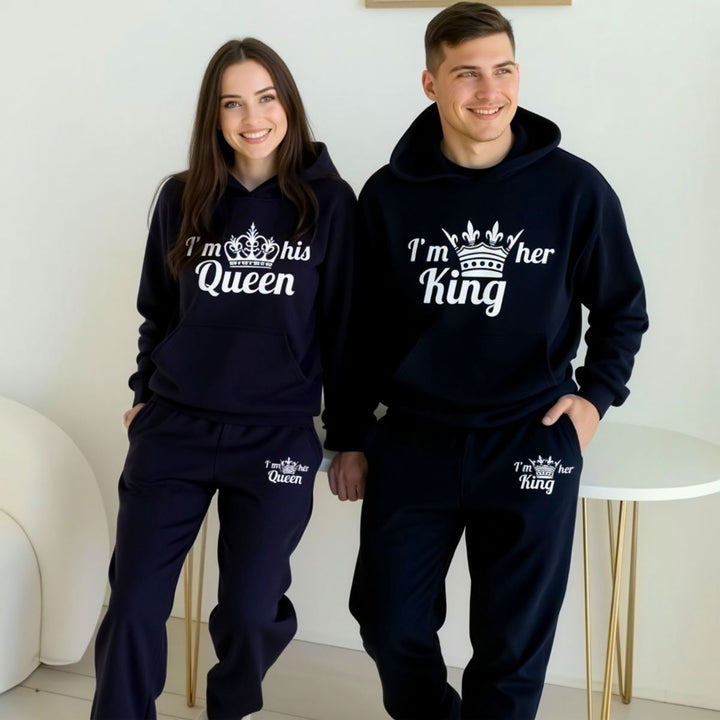 Matching black King and Queen couples tracksuits with white crown prints and bold text reading 'I'm her King' and 'I'm his Queen,' from CouplesChoices.com. Perfect for stylish partners looking to showcase their love.
