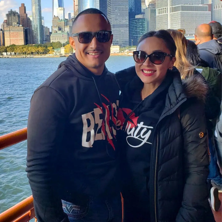 Matching black couple hoodies from CouplesChoices.com with bold white text—his reads “BEAST” with red claw marks, and hers says “Beauty” with a red lipstick kiss graphic. A fun, edgy set for couples who embrace fierce love and playful contrasts.