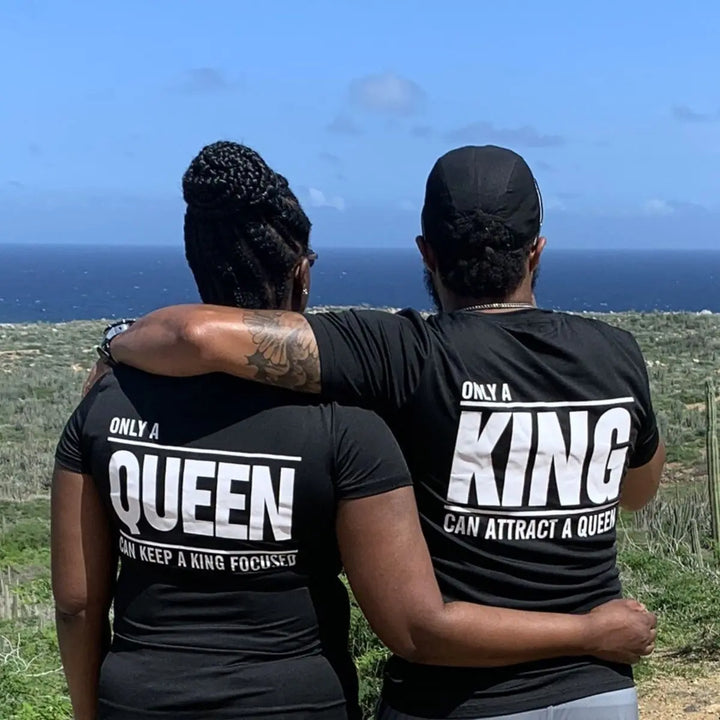 Matching black couple shirts—his says 'Only a King Can Attract a Queen,' hers reads 'Only a Queen Can Keep a King Focused.' A bold, empowering duo from CouplesChoices.com celebrating royalty in love.