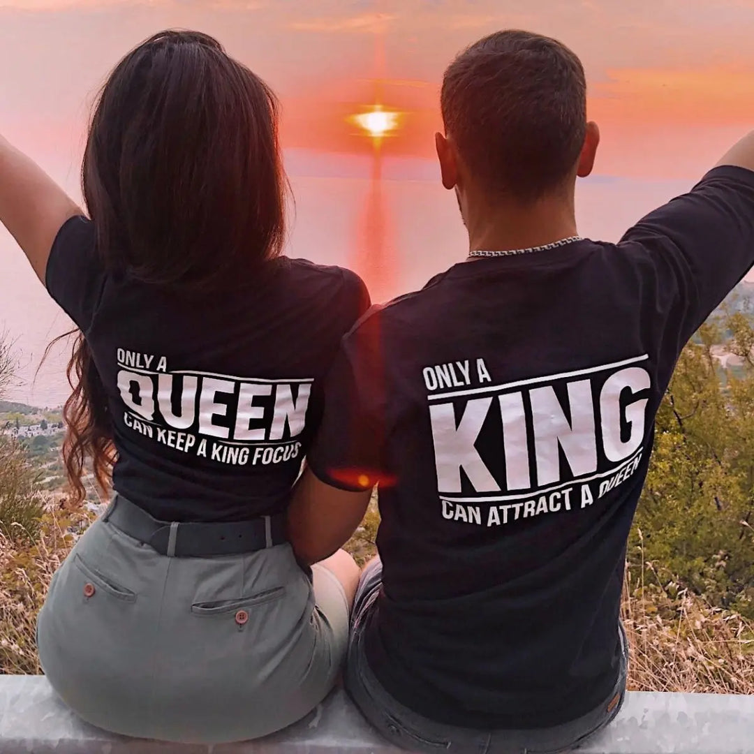 Matching black couple shirts—his says 'Only a King Can Attract a Queen,' hers reads 'Only a Queen Can Keep a King Focused.' A bold, empowering duo from CouplesChoices.com celebrating royalty in love.