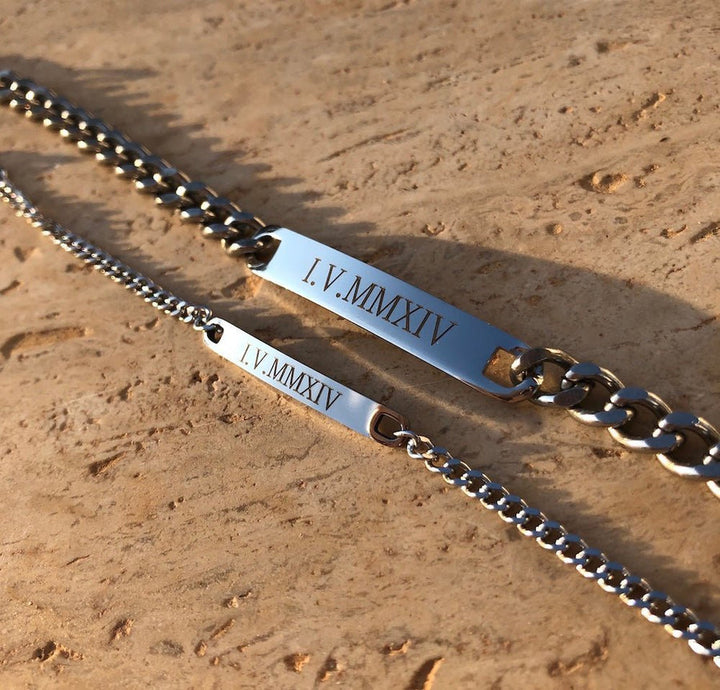 Matching engraved couple bracelets with minimalist chain link design in silver, gold, and black finishes, featuring personalized nameplate tags—romantic gift for couples by CouplesChoices.com.