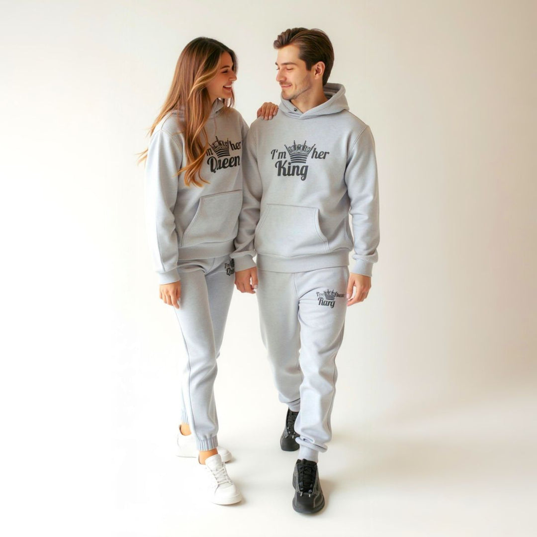 Matching gray King and Queen tracksuits for couples from CouplesChoices.com, featuring crown graphics and bold 'I'm her King' and 'I'm his Queen' prints on hoodies and joggers—crafted for comfort, unity, and standout street style.