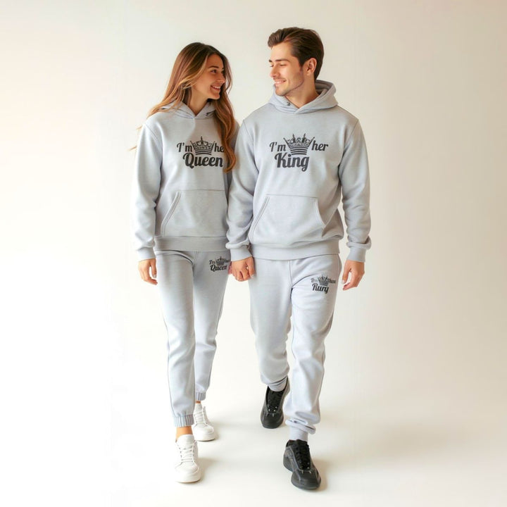 Matching gray King and Queen tracksuits for couples from CouplesChoices.com, featuring crown graphics and bold 'I'm her King' and 'I'm his Queen' prints on hoodies and joggers—crafted for comfort, unity, and standout street style.