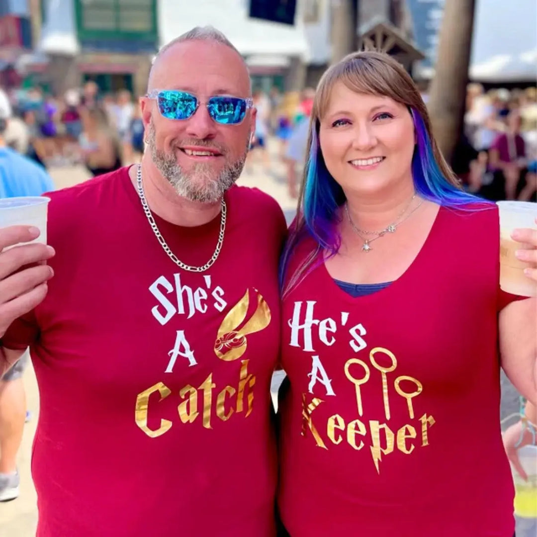 Matching maroon couple shirts with gold foil text: 'She’s a Catch' featuring a golden snitch, and 'He’s a Keeper' with Quidditch goalposts – perfect for Potterhead pairs.