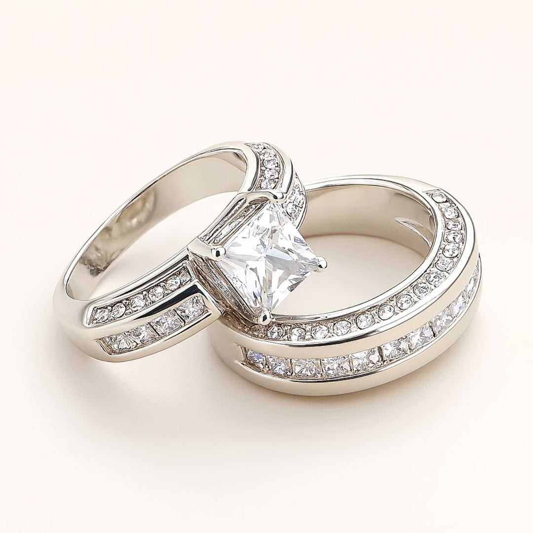 Miracle Ring Set by CouplesChoices.com showcasing a princess-cut center stone on a pavé-set engagement ring, paired with a matching eternity band and a coordinating dual-row men’s band in polished white gold—crafted for timeless brilliance.