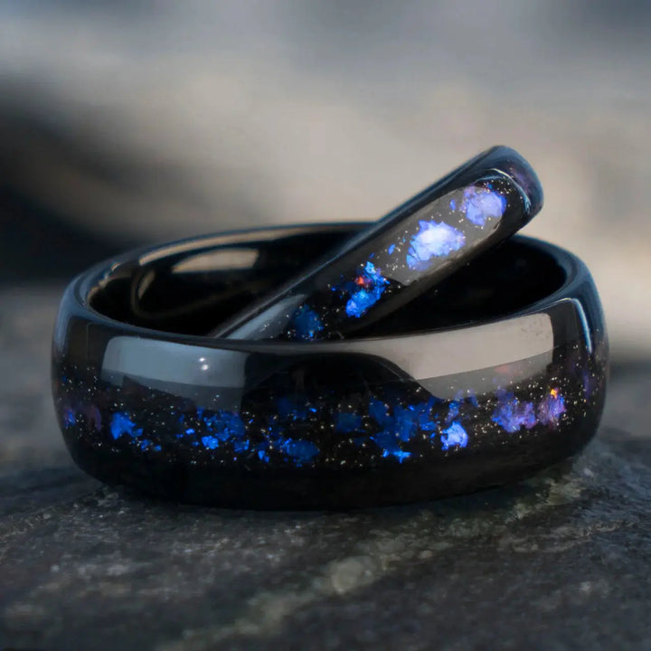 Nebula Rings by CouplesChoices.com—tungsten carbide wedding bands infused with cosmic opal inlays, evoking the deep blue glow of a distant galaxy. A bold, celestial design for couples who share a love as infinite as the stars.