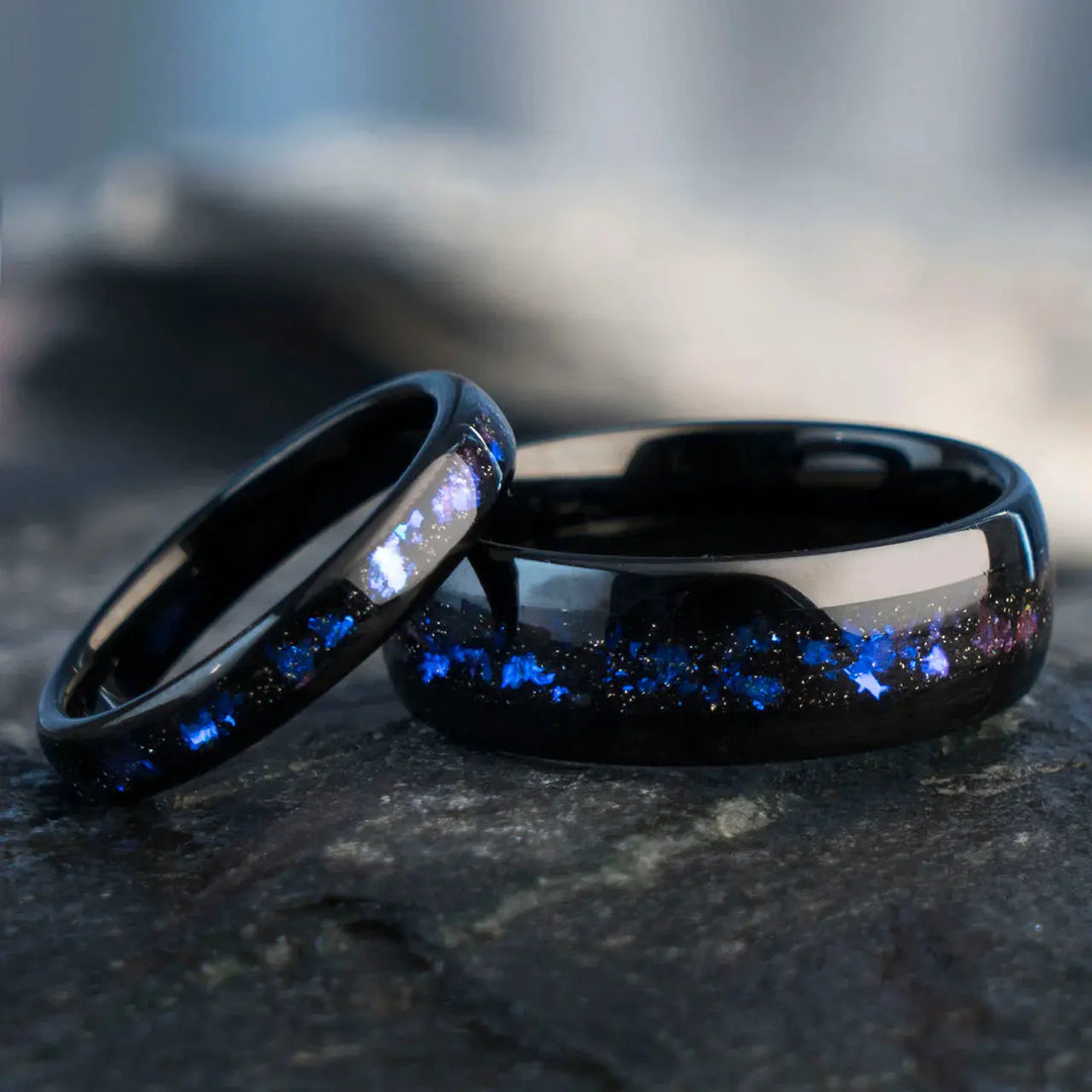Nebula Rings by CouplesChoices.com—tungsten carbide wedding bands infused with cosmic opal inlays, evoking the deep blue glow of a distant galaxy. A bold, celestial design for couples who share a love as infinite as the stars.