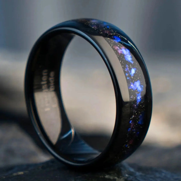 Nebula Rings by CouplesChoices.com—tungsten carbide wedding bands infused with cosmic opal inlays, evoking the deep blue glow of a distant galaxy. A bold, celestial design for couples who share a love as infinite as the stars.
