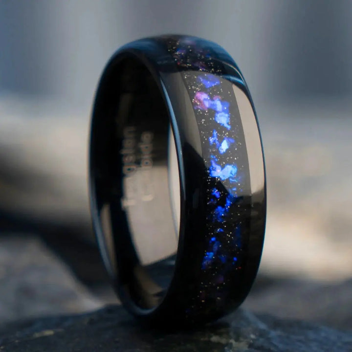 Nebula Rings by CouplesChoices.com—tungsten carbide wedding bands infused with cosmic opal inlays, evoking the deep blue glow of a distant galaxy. A bold, celestial design for couples who share a love as infinite as the stars.