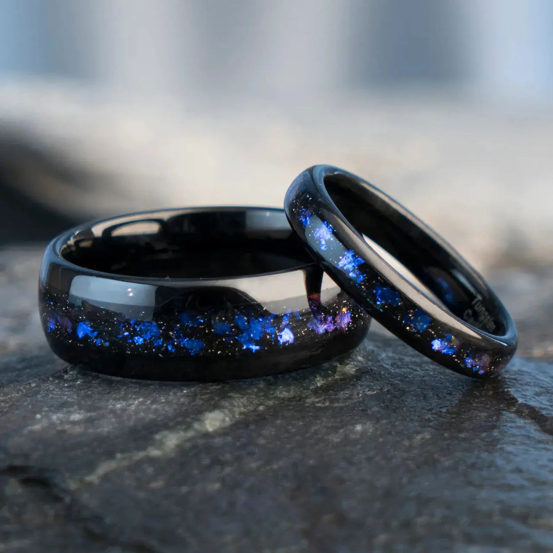 Nebula Rings by CouplesChoices.com—tungsten carbide wedding bands infused with cosmic opal inlays, evoking the deep blue glow of a distant galaxy. A bold, celestial design for couples who share a love as infinite as the stars.