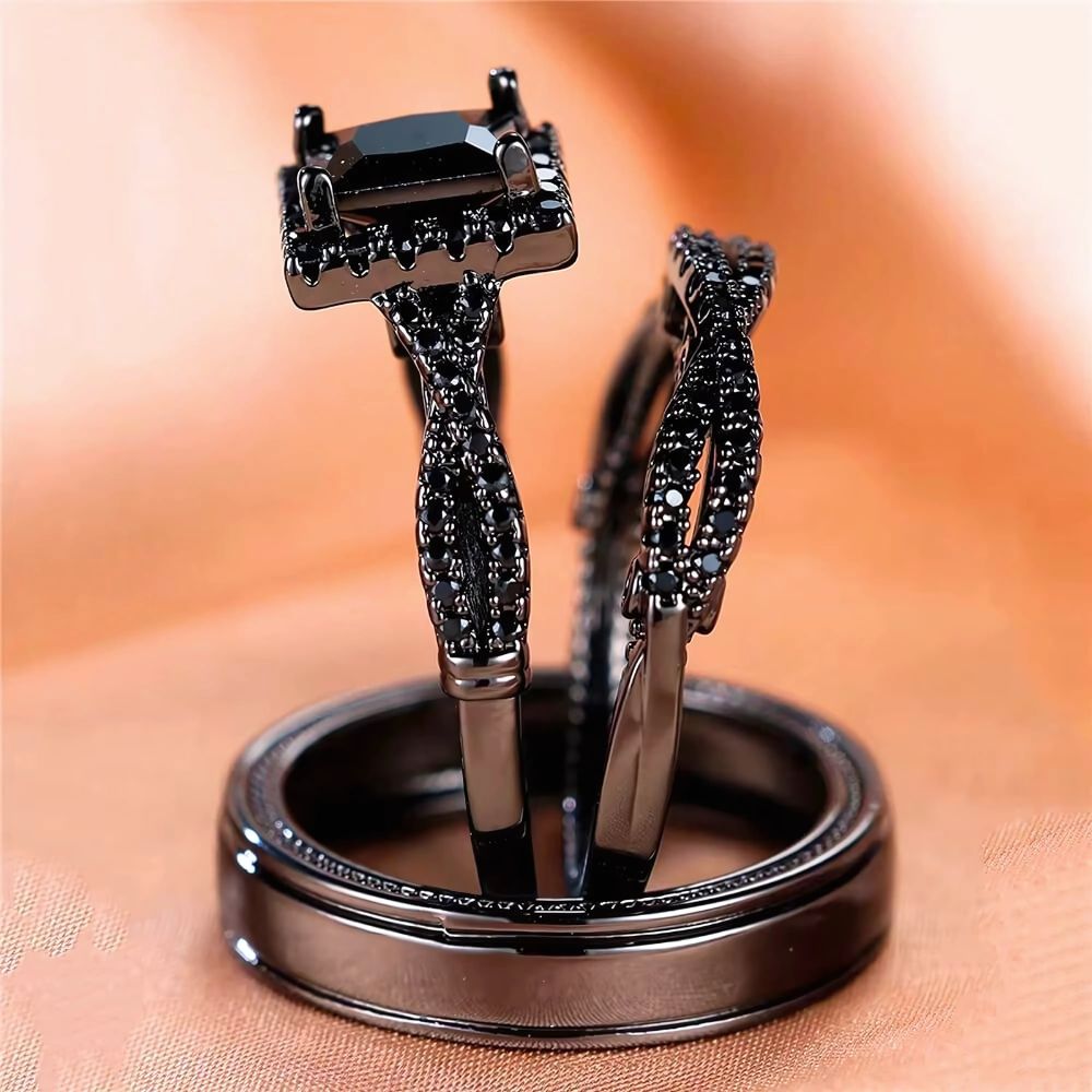 Noir Rings by CouplesChoices.com, featuring a bold black princess-cut engagement ring with pavé black gemstone detailing and matching black tungsten bands—designed to embody elegance, power, and modern romance.