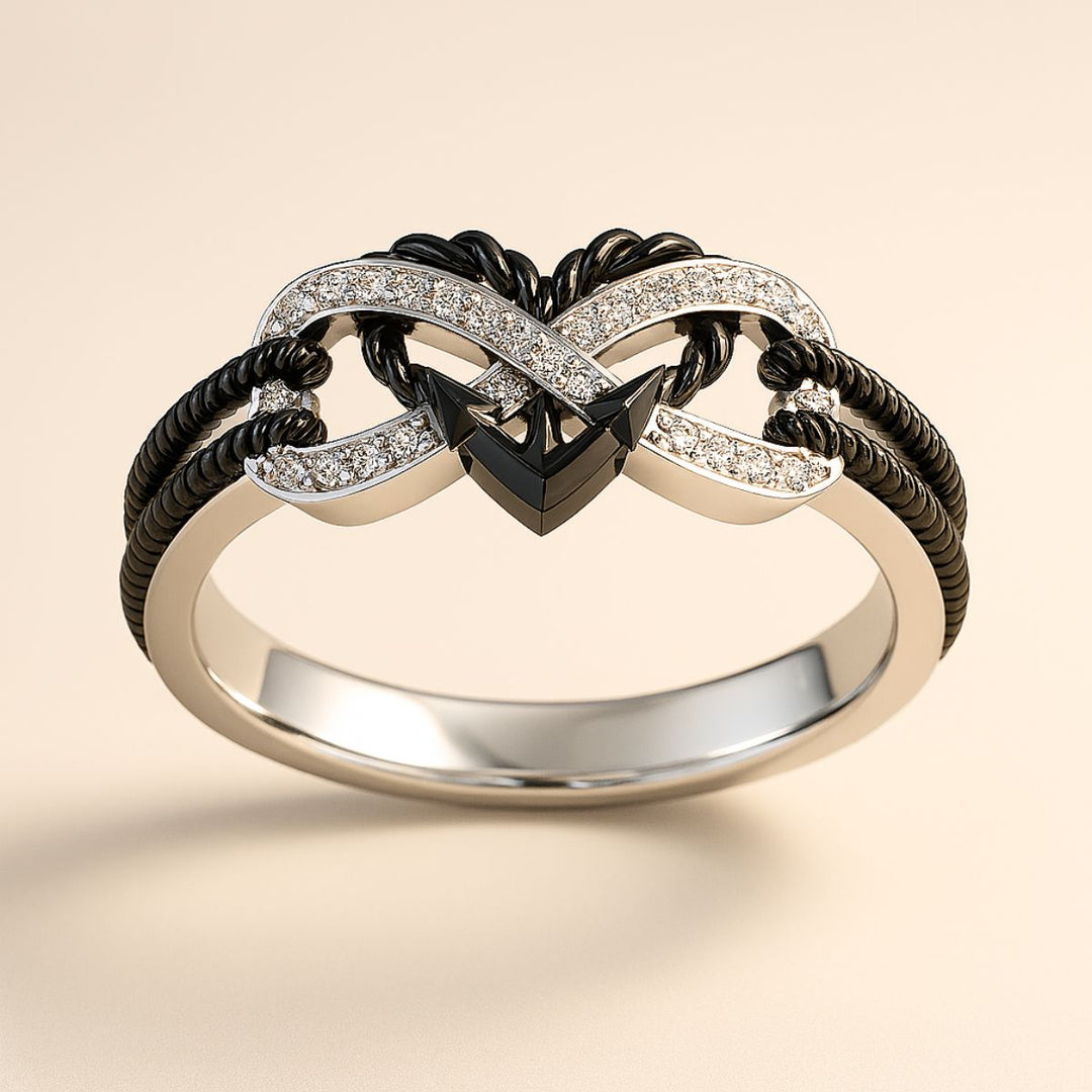 Passion ring set by CouplesChoices.com, featuring a diamond-studded infinity heart with black rope detail and a bold black chain-link men’s band—symbolizing unbreakable, fearless love.