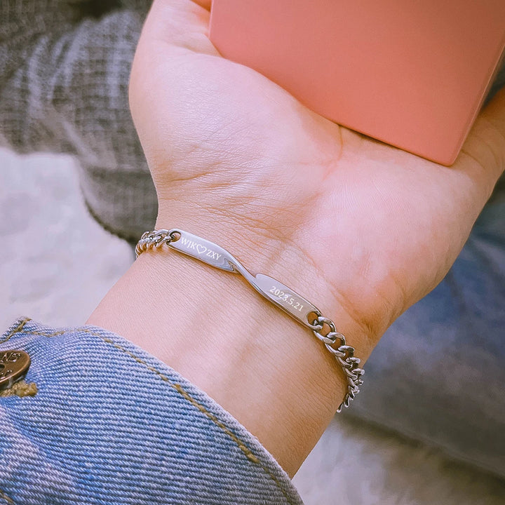 Personalized couples bracelets with twisted engraved nameplates and adjustable chain links, available in silver, gold, and rose gold—romantic matching gift from CouplesChoices.com.