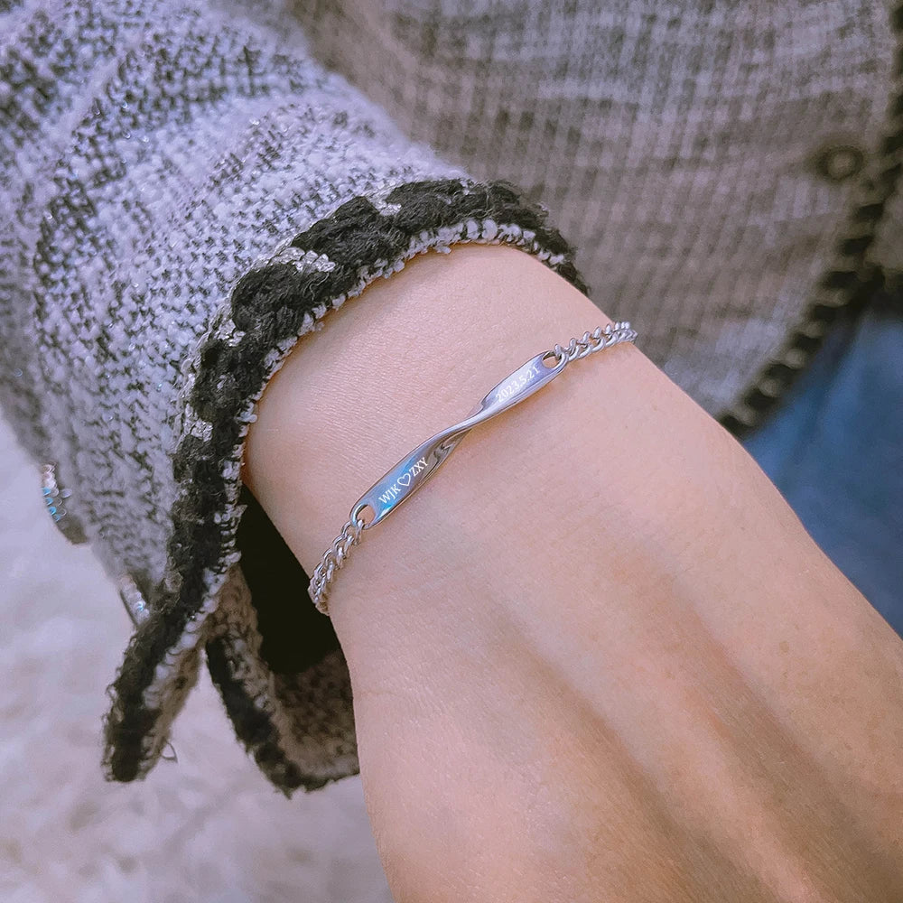 Personalized couples bracelets with twisted engraved nameplates and adjustable chain links, available in silver, gold, and rose gold—romantic matching gift from CouplesChoices.com.