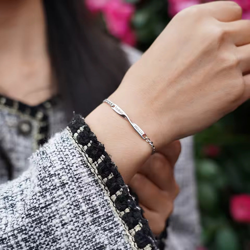 Personalized couples bracelets with twisted engraved nameplates and adjustable chain links, available in silver, gold, and rose gold—romantic matching gift from CouplesChoices.com.