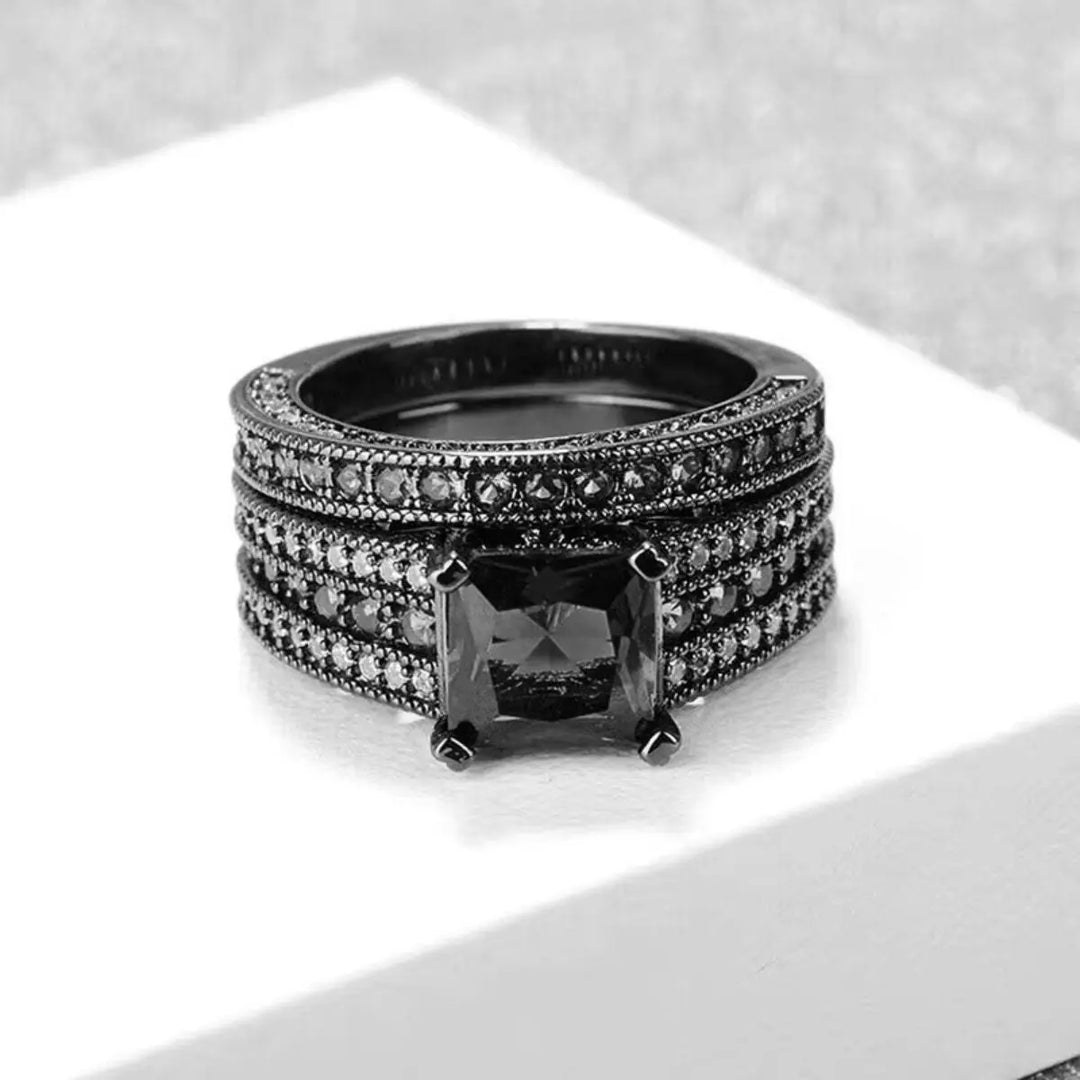 Sleek and bold, the Night Magic Rings from CouplesChoices.com feature a striking black princess-cut stone and matching band, designed for couples who dare to stand out with timeless elegance and powerful unity.