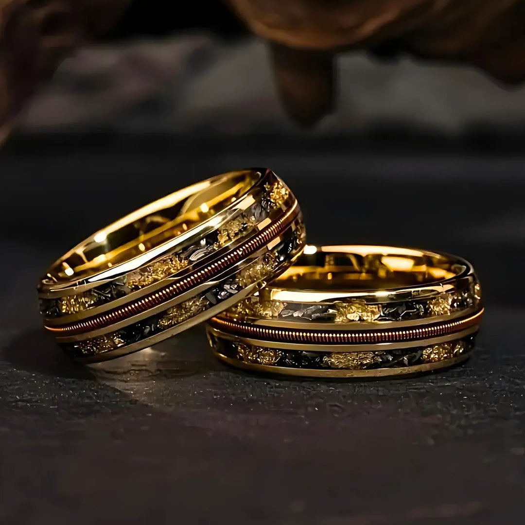 Starforged gold couple rings by CouplesChoices.com, featuring black and gold meteorite inlays and a central textured copper band—symbolizing strength, unity, and timeless elegance.