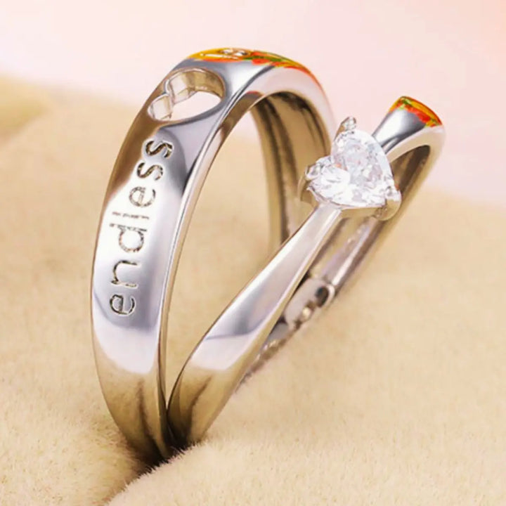 The Endless Love Rings from CouplesChoices.com feature elegant silver bands engraved with “endless love,” crowned by a heart-cut stone—perfectly symbolizing a forever bond built on devotion, simplicity, and timeless romance.
