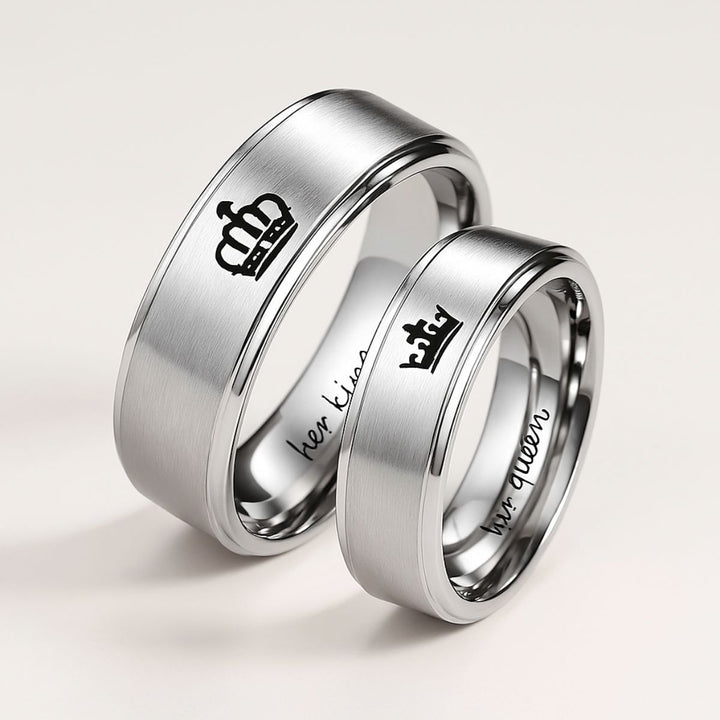 Timeless Exhilaration Rings by CouplesChoices.com—brushed silver bands engraved with elegant crown icons and inner "Her King" & "His Queen" inscriptions. A sleek, modern symbol of eternal love, loyalty, and royalty-inspired devotion.