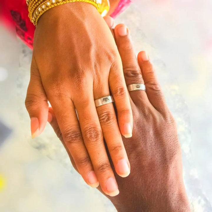 Timeless Exhilaration Rings by CouplesChoices.com—brushed silver bands engraved with elegant crown icons and inner "Her King" & "His Queen" inscriptions. A sleek, modern symbol of eternal love, loyalty, and royalty-inspired devotion.