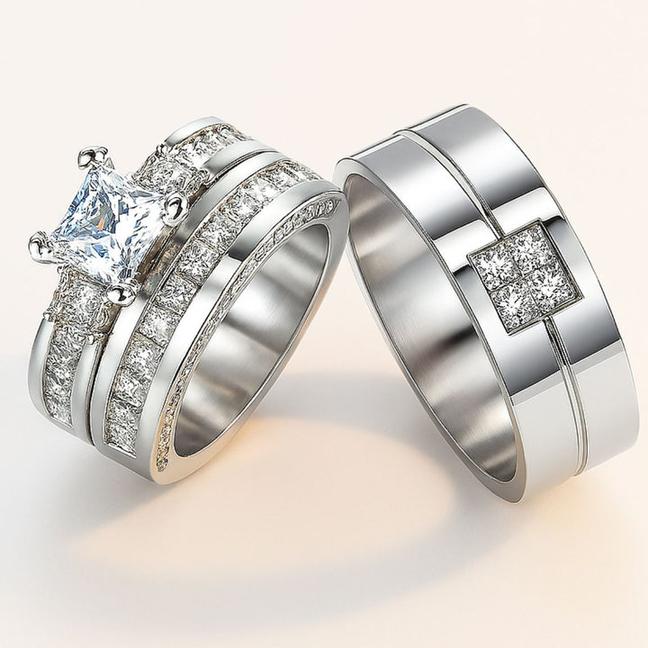 Timelessly elegant Honey Moon Rings by CouplesChoices.com, featuring a princess-cut centerpiece flanked by dazzling side stones, perfectly paired with a sleek men’s band adorned with a square cluster of pavé diamonds.