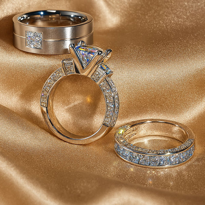 Timelessly elegant Honey Moon Rings by CouplesChoices.com, featuring a princess-cut centerpiece flanked by dazzling side stones, perfectly paired with a sleek men’s band adorned with a square cluster of pavé diamonds.