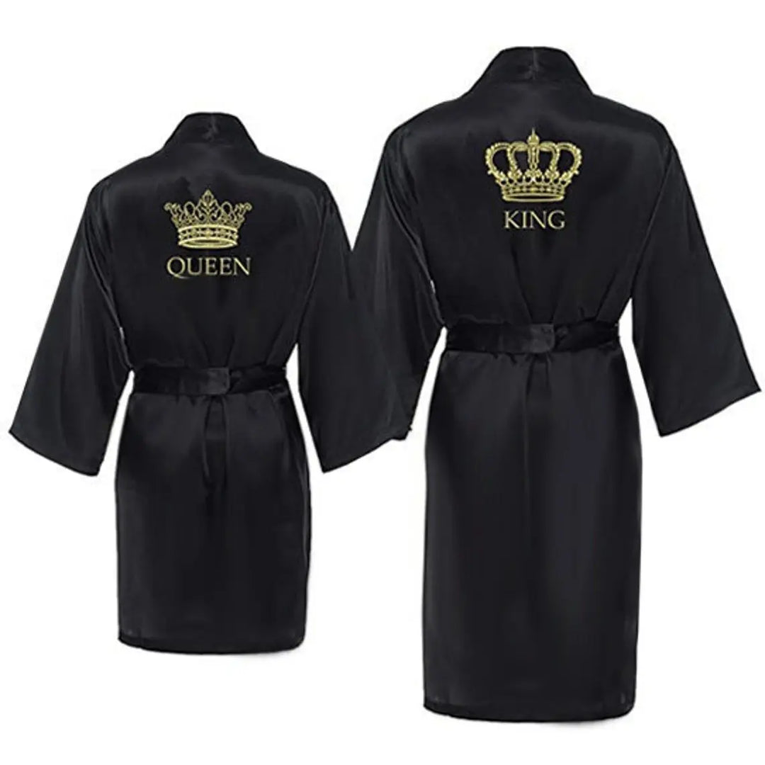 Chic satin black couple’s bathrobes from CouplesChoices.com, featuring regal gold “King” and “Queen” embroidery with intricate crown designs—elegant, lightweight loungewear crafted for style, comfort, and royal romance.