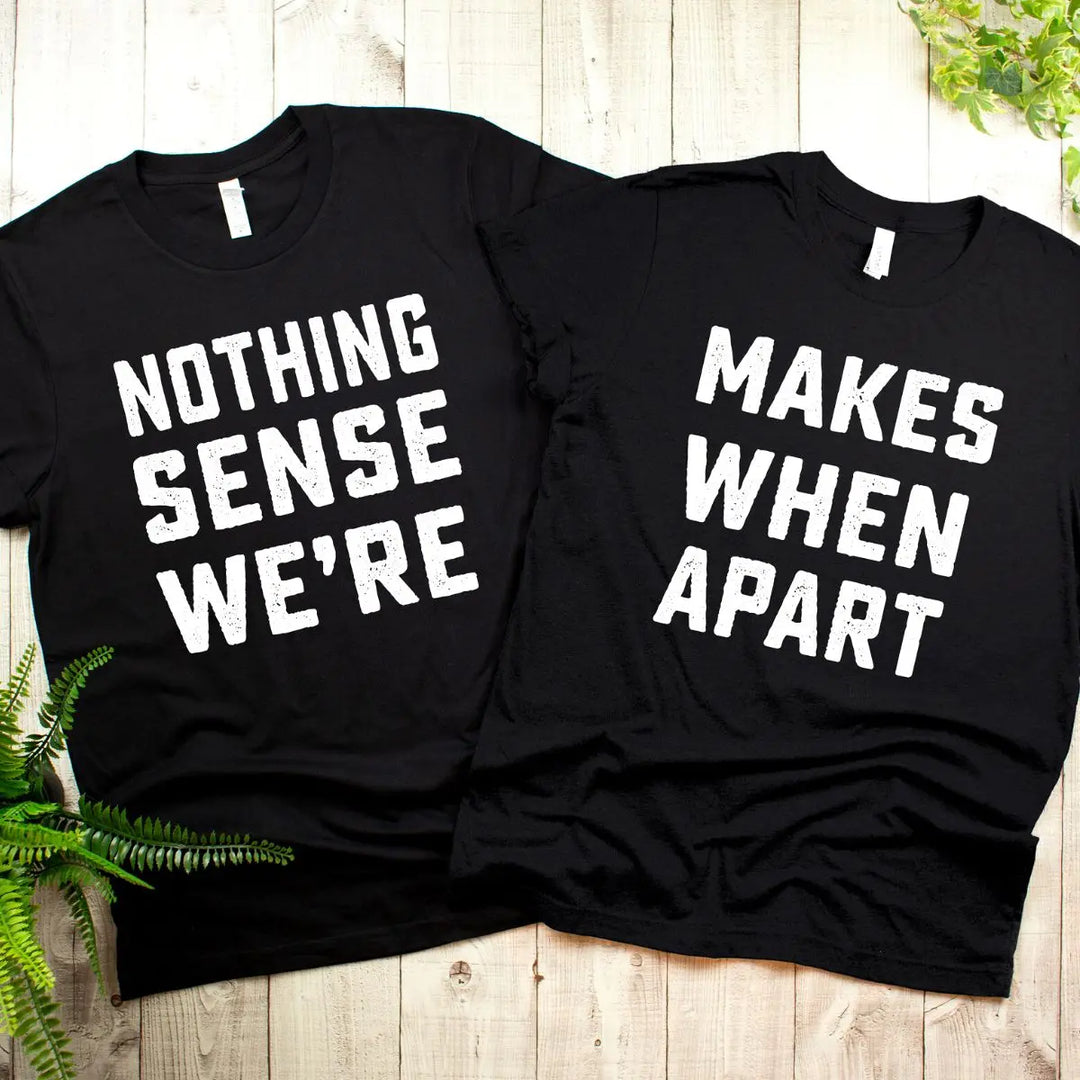 Couple wearing matching black shirts that read 'Nothing Makes Sense We’re' and 'Makes When Apart'—a playful and heartfelt message when worn together. Perfect for couples who want to show love and humor. From CouplesChoices.com.