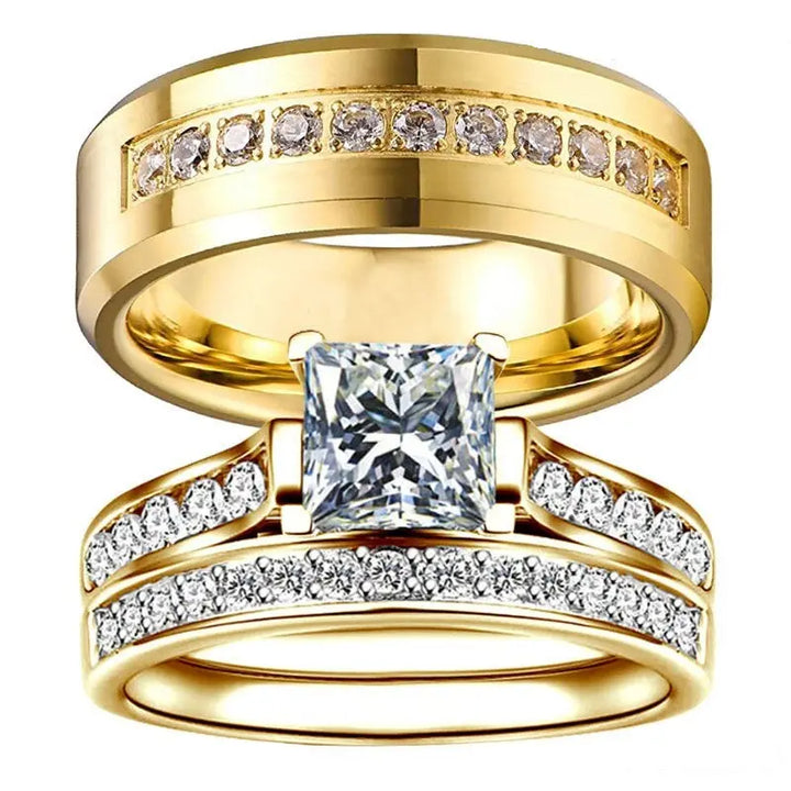 CouplesChoices.com Gold Royalty Rings – A radiant bridal set with a princess-cut diamond and pavé accents, paired with a bold men’s gold band featuring channel-set diamonds. A powerful symbol of regal love and lifelong unity.