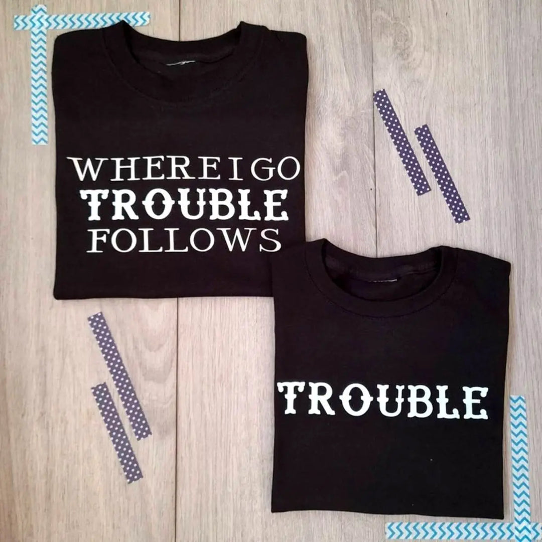 Couples black matching shirts from CouplesChoices.com—one reads “WHERE I GO TROUBLE FOLLOWS,” the other simply says “TROUBLE.” A cheeky, confident way to show playful love and unforgettable chemistry.