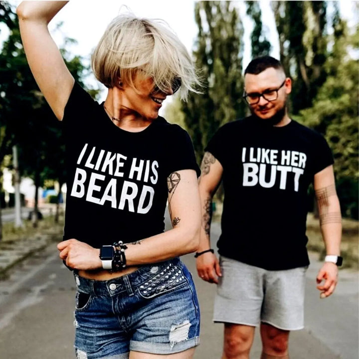 Couples matching black T-shirts from CouplesChoices.com—hers reads “I Like His Beard” and his says “I Like Her Butt.” A fun, cheeky way to show off attraction, personality, and a playful connection in modern relationships.