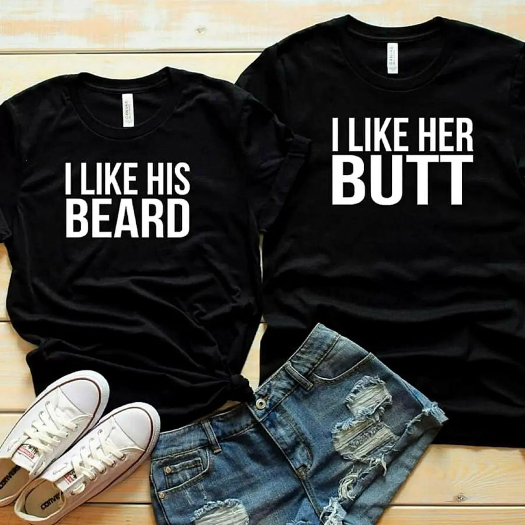 Couples matching black T-shirts from CouplesChoices.com—hers reads “I Like His Beard” and his says “I Like Her Butt.” A fun, cheeky way to show off attraction, personality, and a playful connection in modern relationships.