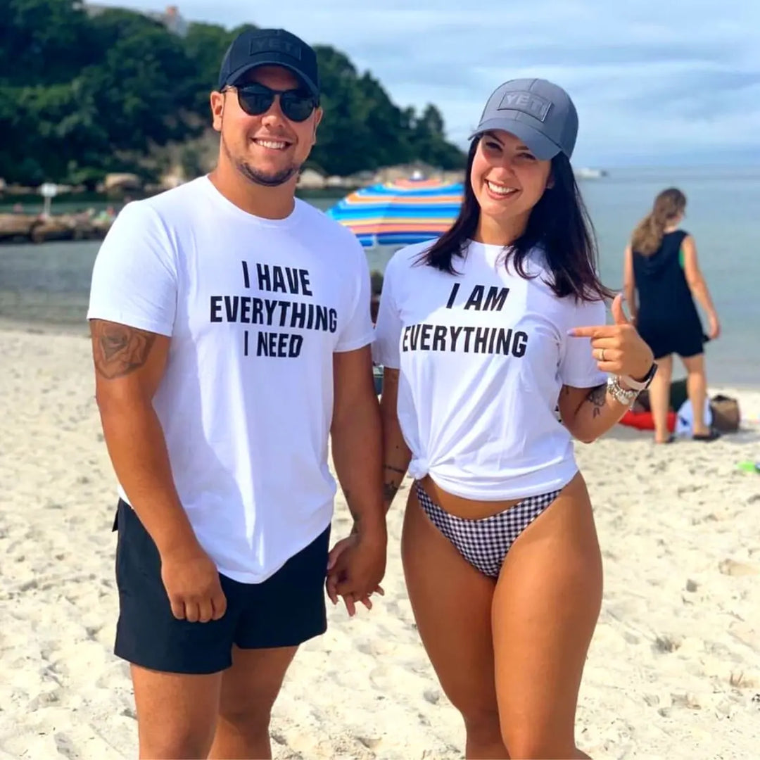 Couples matching white T-shirts from CouplesChoices.com—his says “I Have Everything I Need,” hers says “I Am Everything”—a bold, stylish way to express love, unity, and connection.