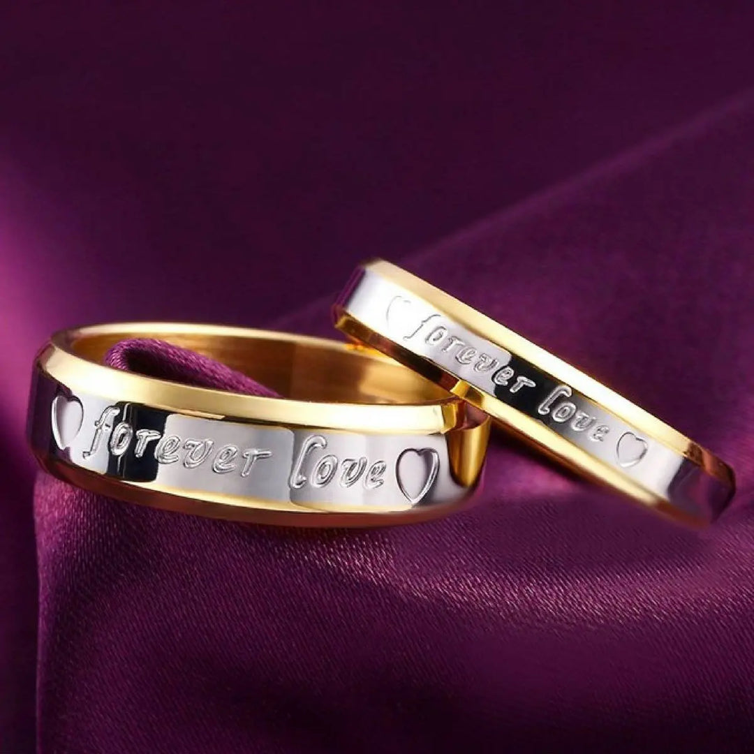 Elegant Forever Love Rings by CouplesChoices.com in radiant gold and silver tones, engraved with hearts and timeless words—crafted to symbolize eternal commitment and cherished connection.