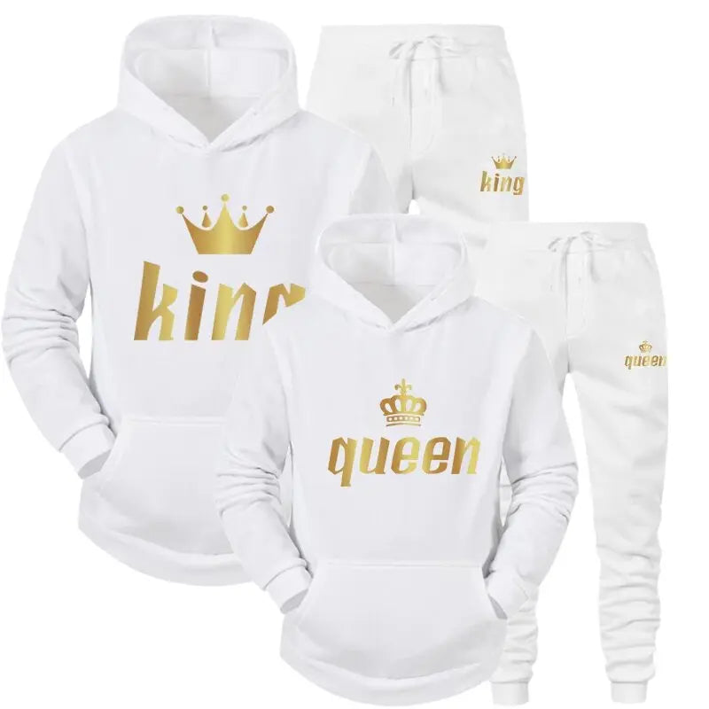 Elegant white matching King and Queen tracksuits from CouplesChoices.com, featuring metallic gold crown prints and bold royal lettering—perfect for stylish couples making a statement.