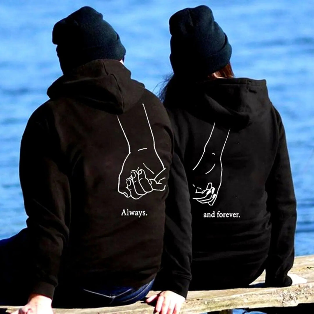 Matching "Always & Forever" couple hoodies in black from CouplesChoices.com, featuring minimalist white line art of intertwined pinkies and romantic typography — the perfect cozy statement for everlasting love and connection.