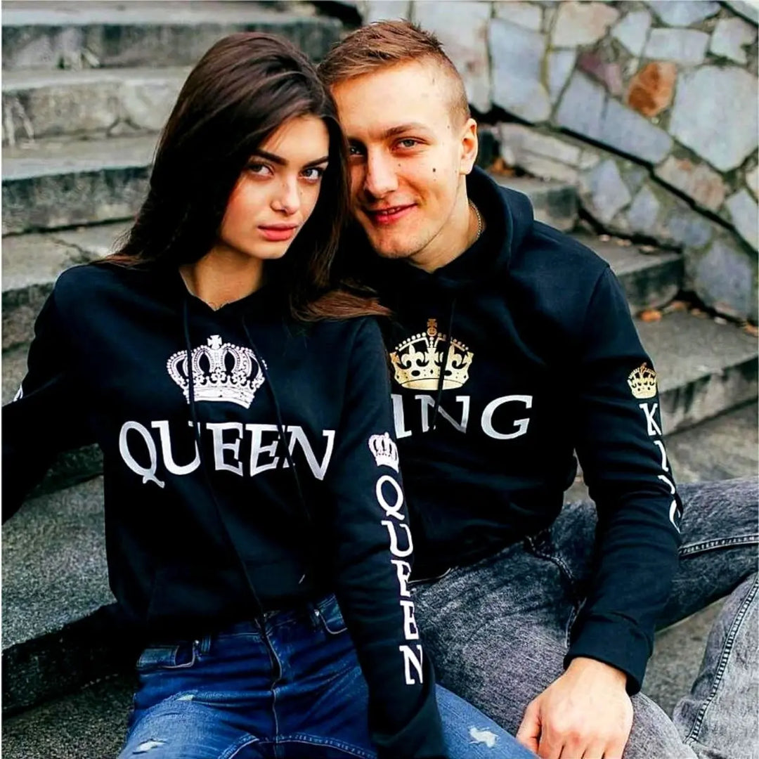 Matching black couple hoodies from CouplesChoices.com with bold white “KING” and “QUEEN” lettering and crown graphics on the chest, sleeves, and hood. A timeless, coordinated set designed for couples who lead with love and royalty.