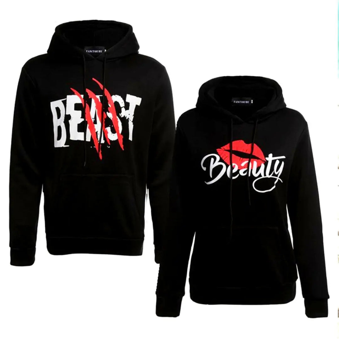 Matching black couple hoodies from CouplesChoices.com with bold white text—his reads “BEAST” with red claw marks, and hers says “Beauty” with a red lipstick kiss graphic. A fun, edgy set for couples who embrace fierce love and playful contrasts.